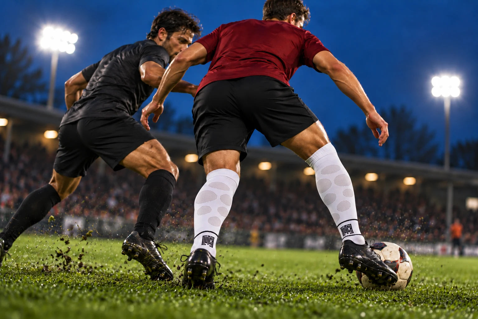 Campaign scene of two players contesting possession under floodlights, seen from behind to show Flex Flow zones only over the calves